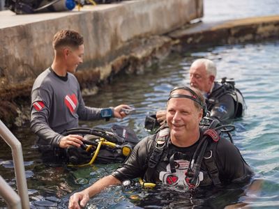 adaptive scuba instructor and adaptive scuba diver buddies training in water