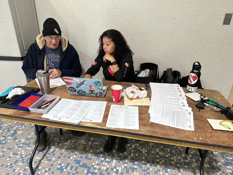 volunteers at a table at pool scuba experience